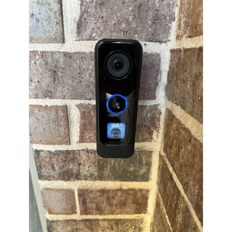 Outdoor security camera mounted on a brick exterior wall.