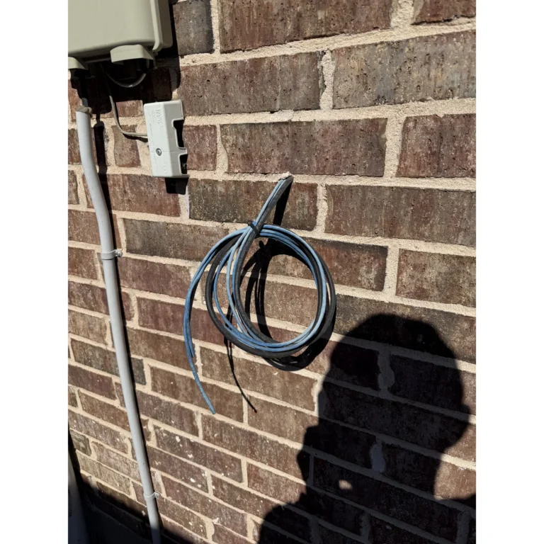 Outdoor network device mounted on a brick exterior wall for connectivity.