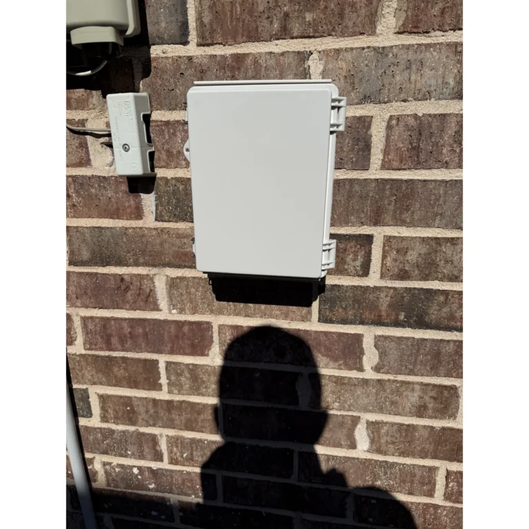 Exterior low-voltage devices mounted on brick with cabling connected.