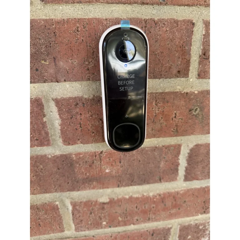Outdoor security camera installed on a brick wall.