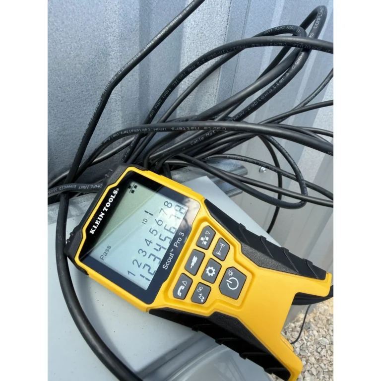 Diagnostic tool and cable staged for network or low-voltage field work.
