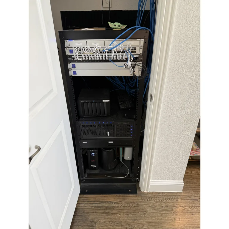 Open network rack with cabling and equipment visible during setup.
