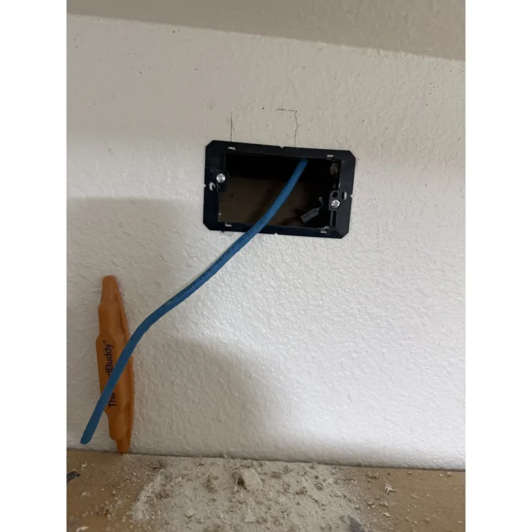 Low-voltage wall box with cabling prepared for device installation and termination.
